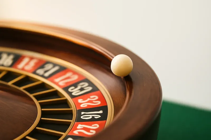 Roulette ball frozen mid-roll on wheel rim with blurred numbers